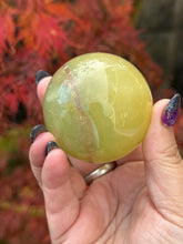 Load image into Gallery viewer, Banded Mango Fluorite Sphere 5.2cm Diameter
