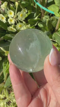 Load and play video in Gallery viewer, Clear Green Fluorite Sphere 4.9cm Dia

